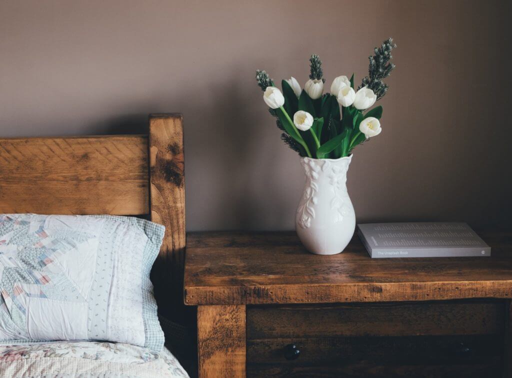 wooden nightstand with flowers